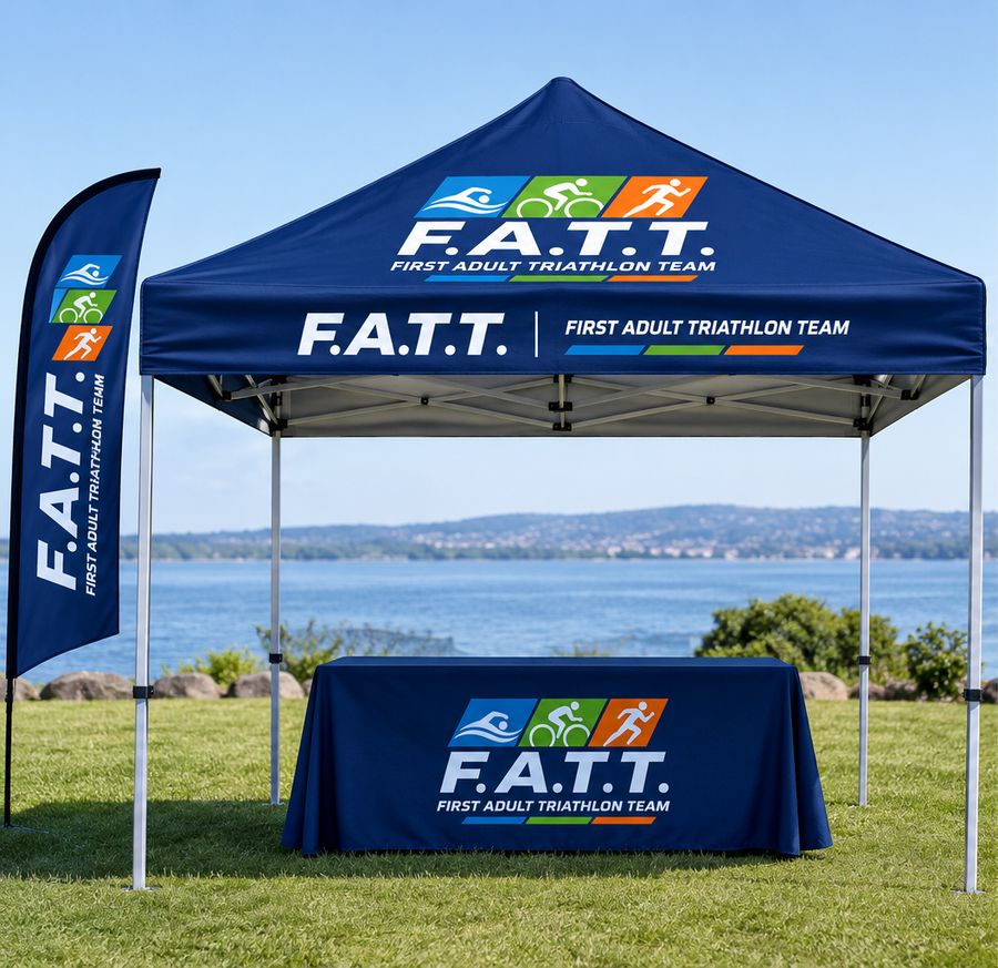 Navy F.A.T.T. team tent with a table and flag on a lakeside lawn